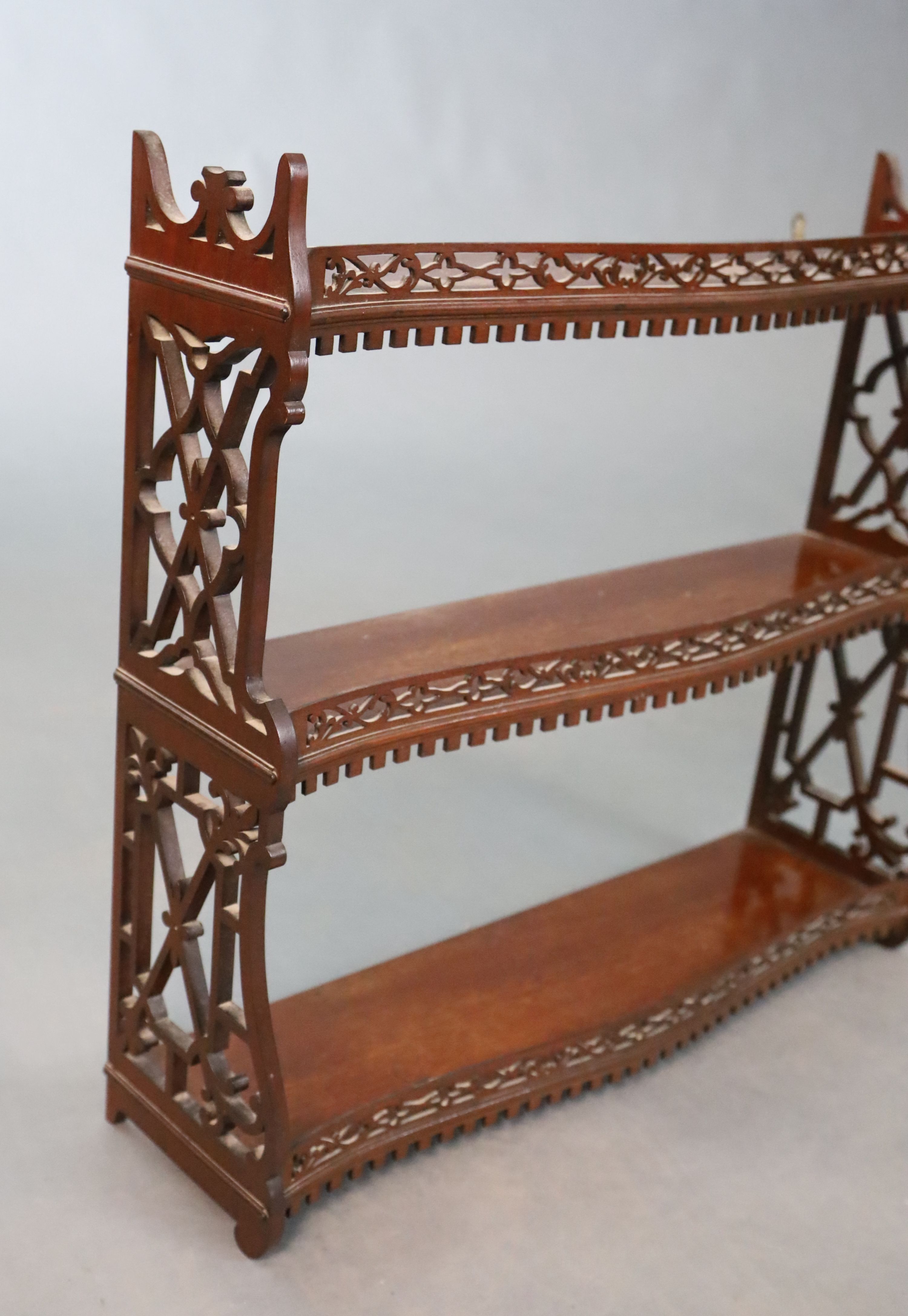 A George II style mahogany three tier wall shelf, W.66cm H.60.5cm